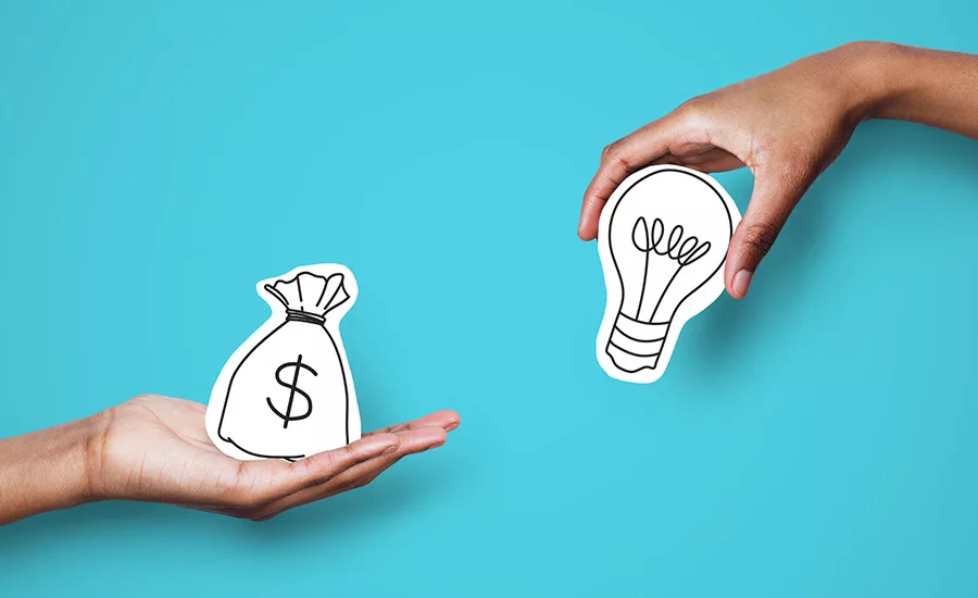 2 hands holding drawn art representing a money bag and a lightbulb
