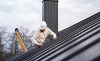 contractor accessing a roof with a ladder