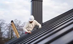 contractor accessing a roof with a ladder