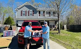Skyline rep and homeowner shaking hands at the reroofing site