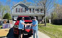 Skyline rep and homeowner shaking hands at the reroofing site
