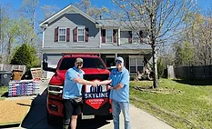 Skyline rep and homeowner shaking hands at the reroofing site