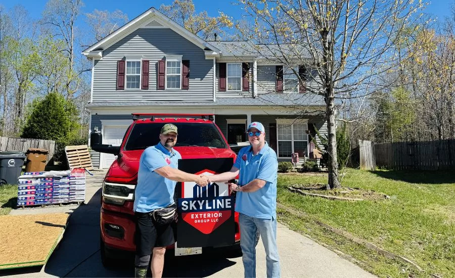 Skyline rep and homeowner shaking hands at the reroofing site