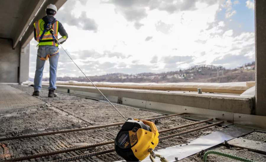 Worker wearing a Werner fall protection harness designed for construction and roofing sites. Worker wearing a Werner fall protection harness designed for construction and roofing sites.