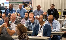 attendees at an educational session wearing headphones