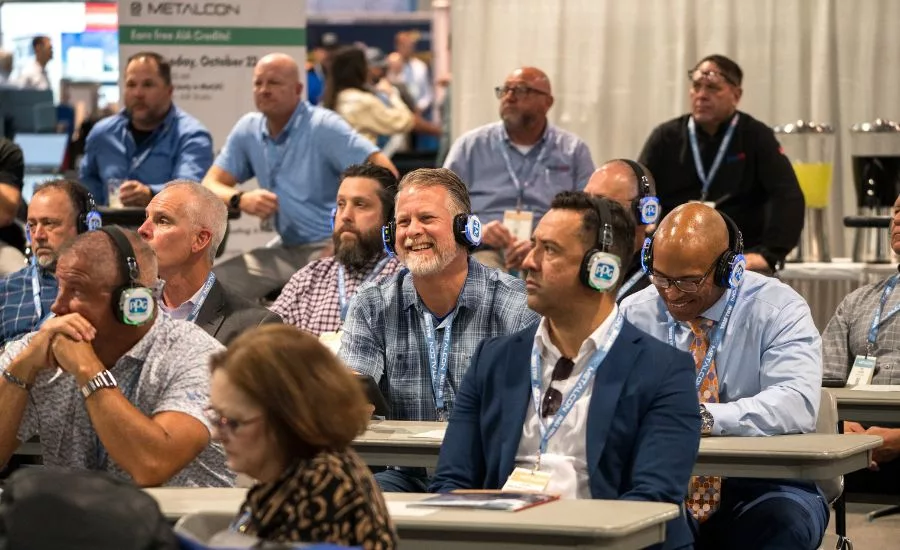 attendees at an educational session wearing headphones