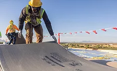 Roofers installing DexCell coverboards