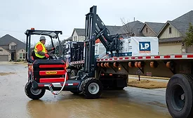 A forklift unloading roofing shingles