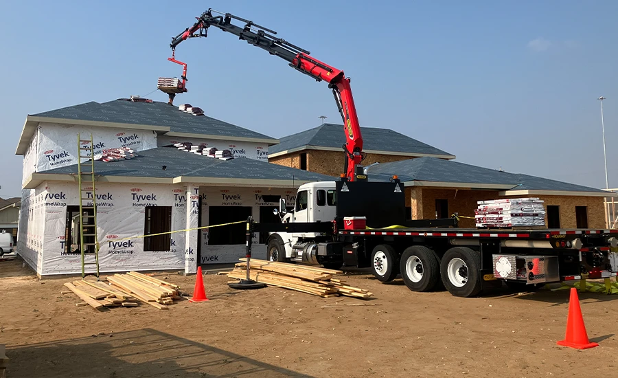 A crane lifting roofing materials
