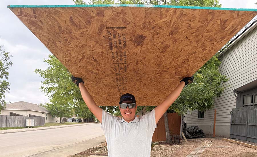 A man carrying a cover board