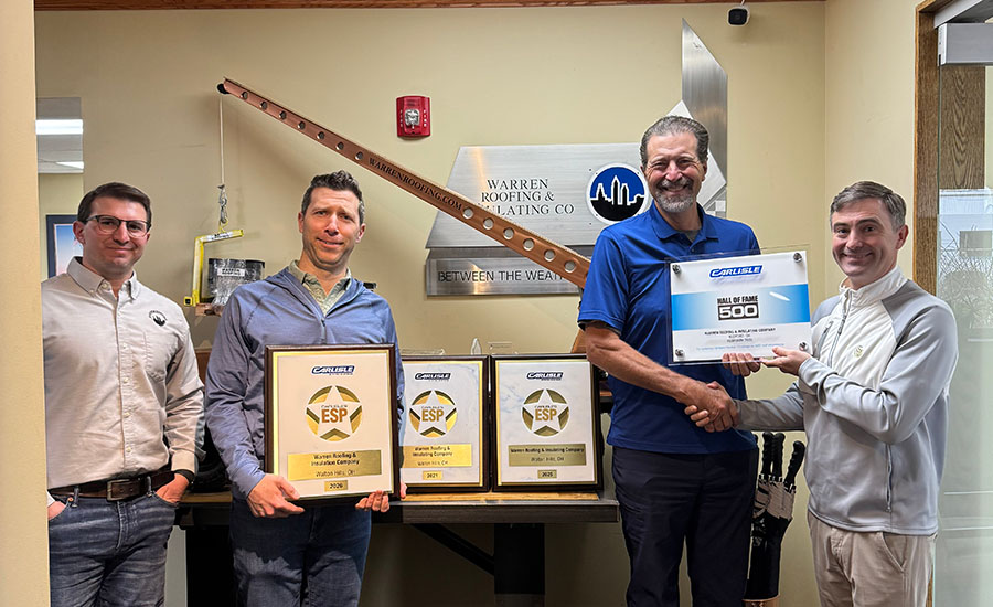 The staff from Extera Building Solutions poses with some of their awards