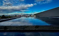 Superior Roofing LLC. A completed roofing project reflecting clouds and sky
