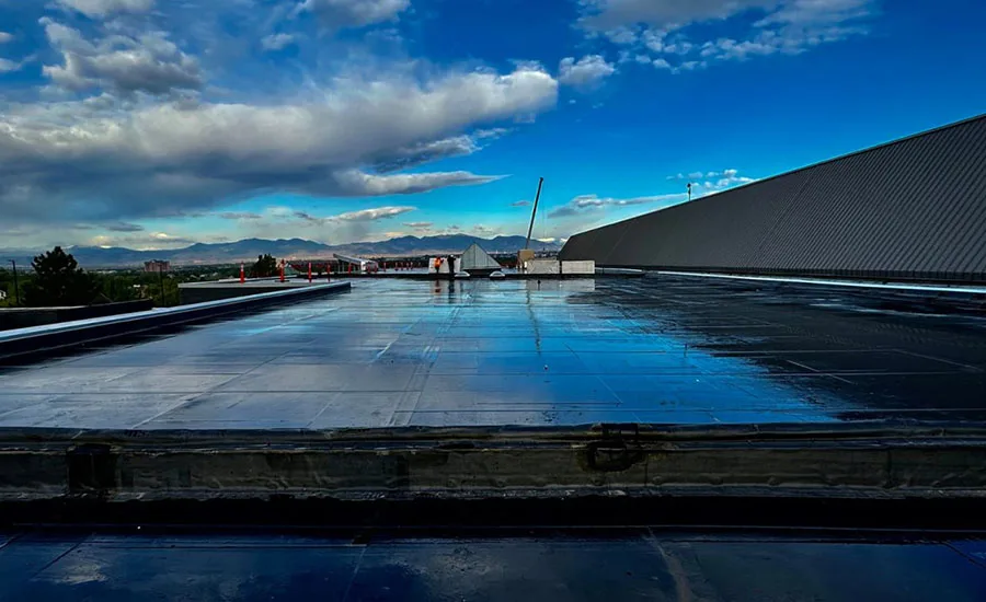 A completed roofing project reflecting clouds and sky