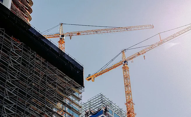 Cranes Photo by Frames For Your Heart on Unsplash.jpg Crane and tower construction