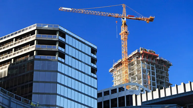 A crane towering over a commercial construction site