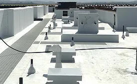 A finished comercial roof with a white coating