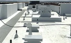 A finished comercial roof with a white coating