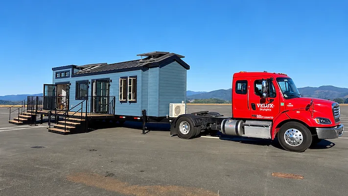 Red Semi-Truck Hauling a Tiny Home.png red semi truck hauling a tiny home
